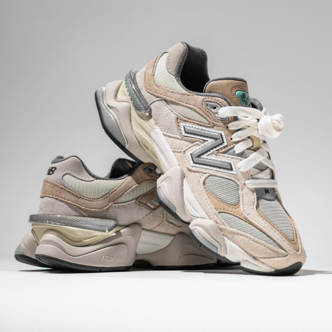 Pair of New Balance 9060 Sea Salt sneakers in beige and gray tones with mixed suede and mesh materials, styled for sneaker enthusiasts. The real deal.