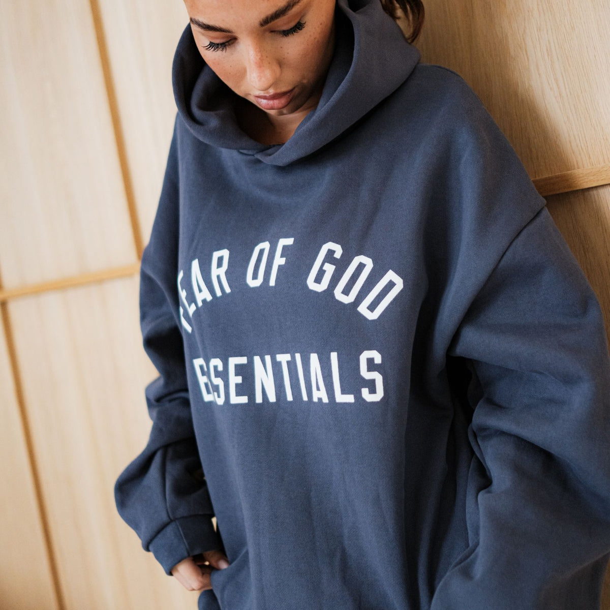 Fear of God Essentials FW24 Marine Full set, detailfoto van voor met wit 'FEAR OF GOD ESSENTIALS' tekst