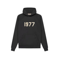 Minimalist black hoodie featuring a bold 1977 print, part of the Fear of God Essentials 1977 Iron Black Full set, perfect for exclusive sneaker and clothing enthusiasts in Europe.