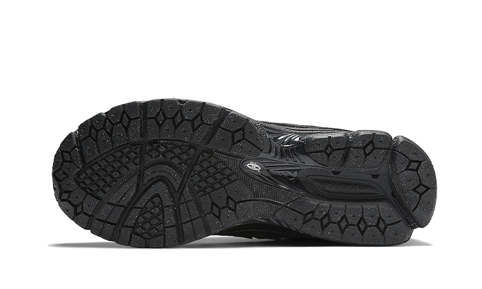 Sole view of New Balance 1906D Protection Pack Black Leather sneaker showcasing durable black rubber outsole with textured grip, designed for traction and support.