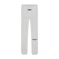 Light oatmeal sweatpants with drawstring waist and elastic cuffs, featuring a subtle "ESSENTIALS" logo, part of the Fear of God Essentials Light Oatmeal Full set, perfect for casual stylish clothing.