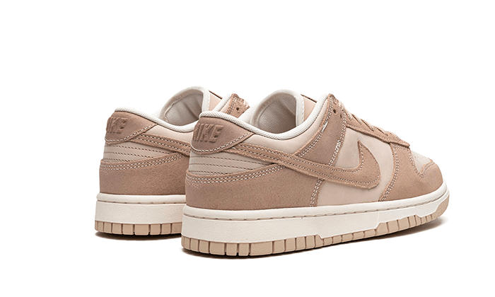 Pair of Nike Dunk Low Sand drift sneakers in light beige and cream tones, showcasing premium suede and leather materials, exclusive to European sneaker enthusiasts.