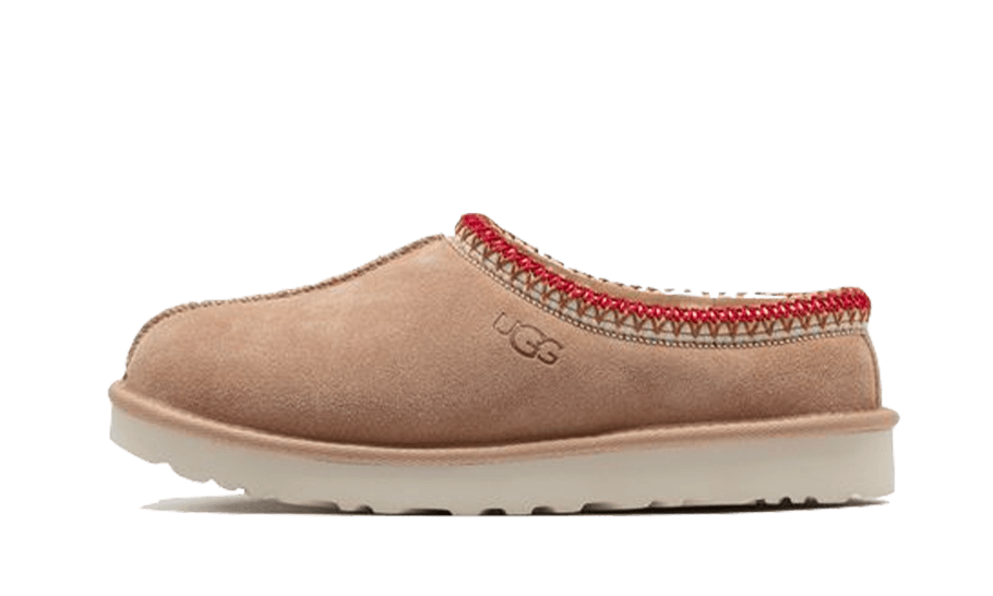 UGG Tasman Slipper Sand Dark Cherry featuring a cozy sand-colored suede upper with a red stitched trim and cushioned sole, perfect for relaxed indoor comfort.