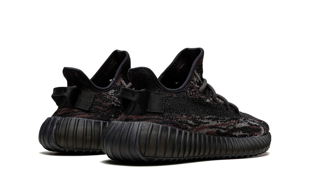 Pair of Adidas Yeezy Boost 350 MX Rock sneakers shown from the back, featuring black and dark gray tones with textured knit upper and ribbed black sole, the real deal.