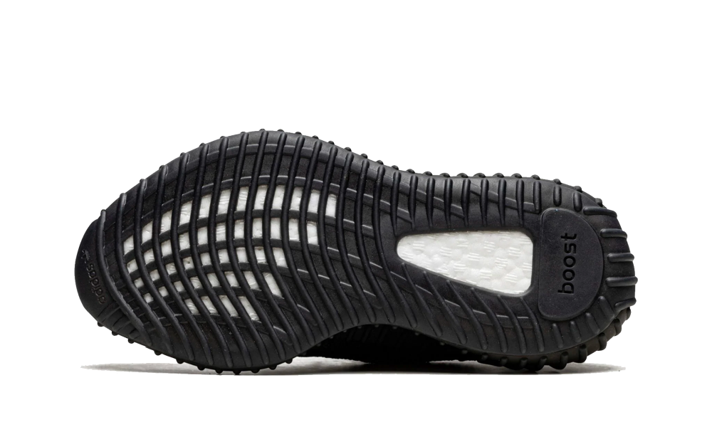 Sole of Adidas Yeezy Boost 350 MX Rock sneaker showing black textured outsole with visible white Boost cushioning and grip patterns, exclusive sneakers Europe The real deal.