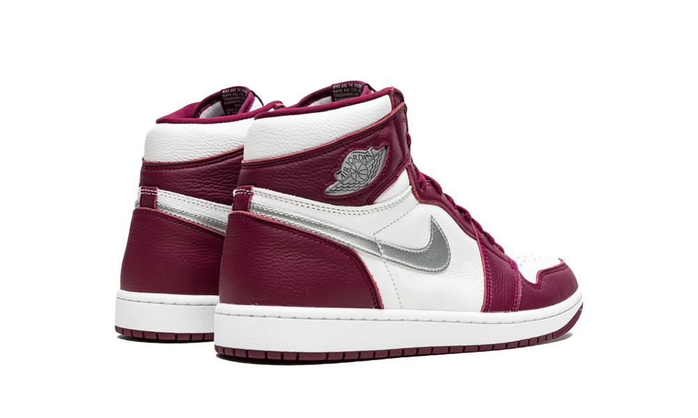 Pair of Nike Air Jordan 1 High OG Bordeaux sneakers in rich burgundy and white leather with silver accents, exclusive in Europe, the real deal for sneaker enthusiasts.