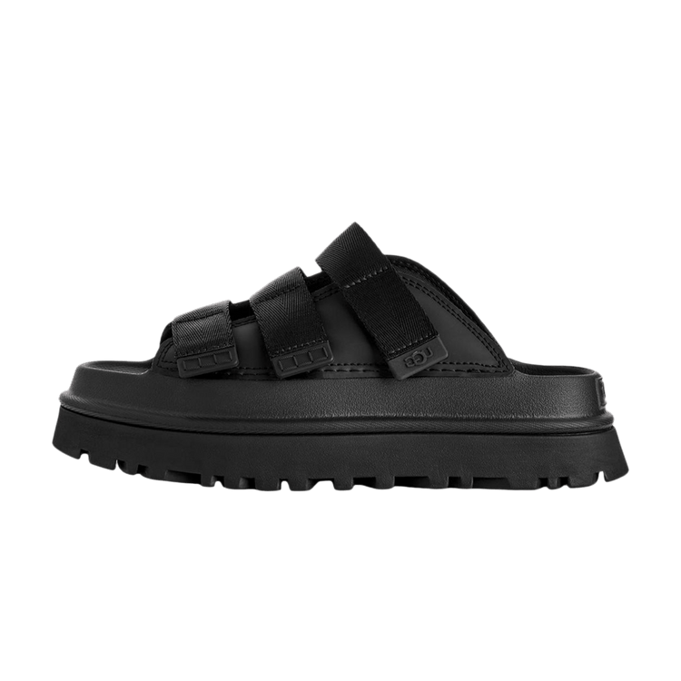 UGG GoldenGlow Slide Black, zijaanzicht met zwarte textielriemen, leren voetbed en lugubrere rubberzool