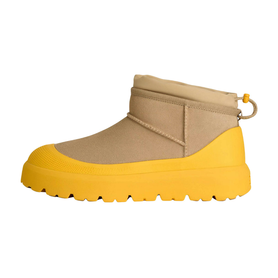 UGG Classic Ultra Mini Weather Hybrid Boot, zijaanzicht met beige suède schacht en gele zool met noppen
