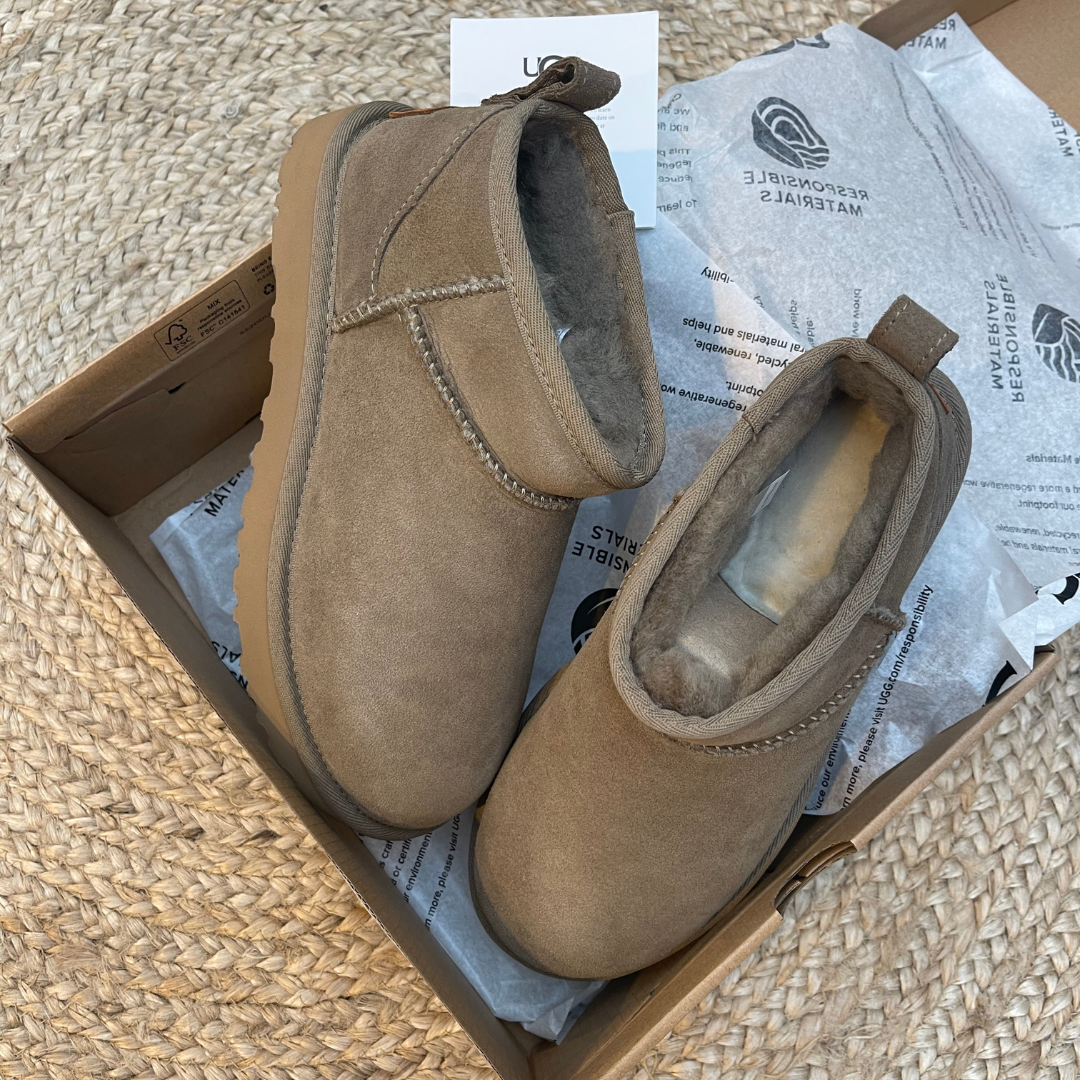 UGG Classic Ultra Mini Antilope sneakers in tan suede with soft plush lining, displayed in a box with eco-friendly personalized wrapping, embodying The real deal.