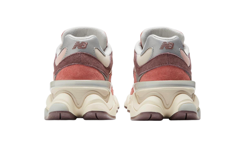 Pair of New Balance 9060 Cherry Blossom sneakers shown from the back, featuring layered suede and mesh in soft pink and beige tones on a chunky outsole, The real deal.