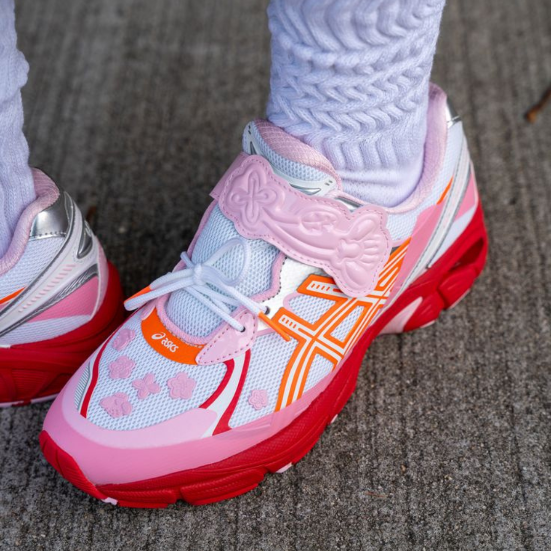 ASICS GT-2160 Cecilie Bahnsen Habanero sneaker in white with pink and red accents, featuring a floral strap detail and worn with textured white socks, representing exclusive European sneaker style.
