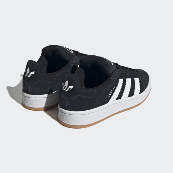 Pair of Adidas Campus 00s GS Core Black Kids sneakers in black suede with white stripes and gum sole, a classic design for exclusive sneaker lovers across Europe. The real deal.