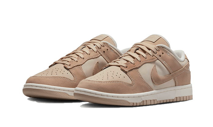 Pair of Nike Dunk Low Sand drift sneakers in beige and tan tones with leather and suede materials, designed for exclusive sneaker enthusiasts in Europe. The real deal.