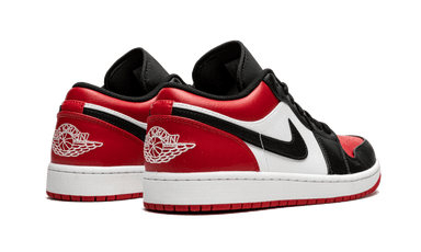 Pair of Nike Air Jordan 1 Low Bred Toe sneakers in black, red, and white colors, showcasing the exclusive and authentic design available across Europe. The real deal.