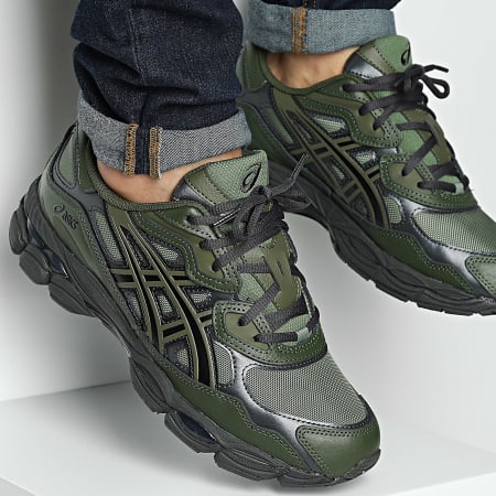 ASICS Gel-NYC Moss Forest sneakers in green and black with mesh and leather details, worn with rolled-up dark denim jeans, showcasing exclusive European style and comfort.