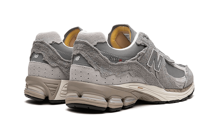 Pair of New Balance 2002R Protection Pack Grey sneakers showcasing textured grey suede overlays, mesh panels, and cushioned soles, perfect for exclusive sneaker collections in Europe.