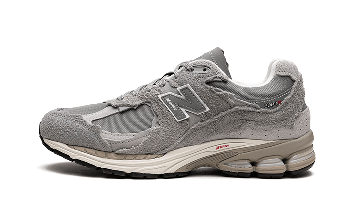 New Balance 2002R Protection Pack Grey sneaker in muted grey tones with textured suede and mesh upper, featuring cushioned sole and branded details, exclusive in Europe.