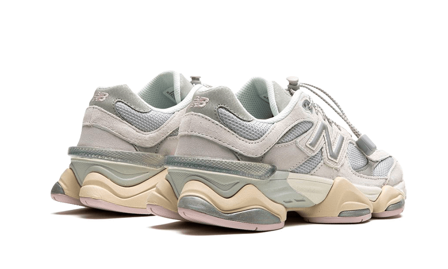 Pair of New Balance 9060 Grey Lilac sneakers in muted grey and lilac tones with chunky beige midsoles, showcasing an exclusive and stylish design perfect for sneaker enthusiasts across Europe.