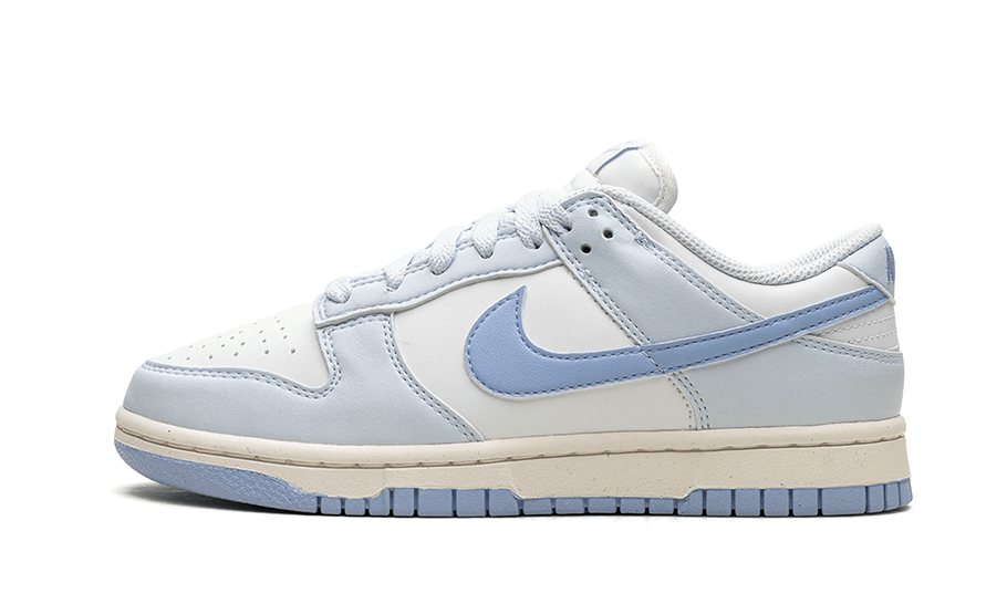Side view of Nike Dunk Low Next Nature Blue Tint sneaker in light blue and white, featuring a classic low-top design and cushioned sole, the real deal exclusive in Europe.