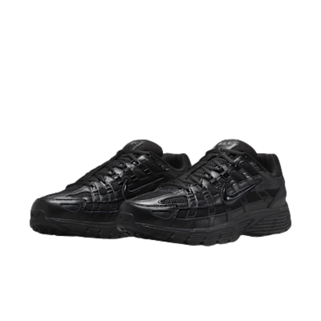 Pair of Nike P-6000 Premium Triple Black sneakers with sleek all-black design, textured overlays, and chunky sole, representing exclusive European sneaker style.