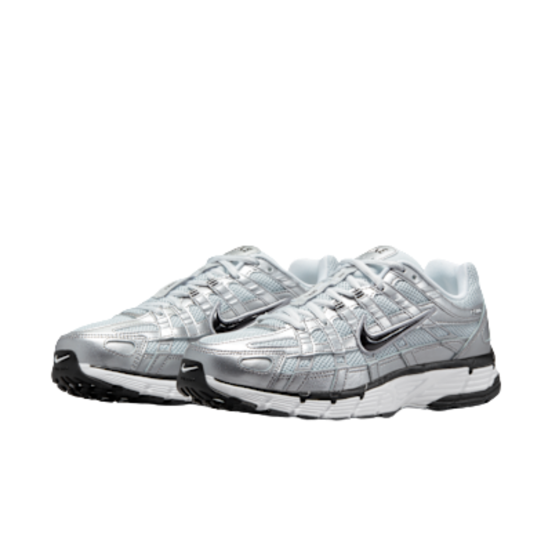 Pair of Nike P-6000 Metallic Silver Pure Platinum sneakers in reflective silver with black and white sole design, showcasing exclusive European sneaker style – The real deal.