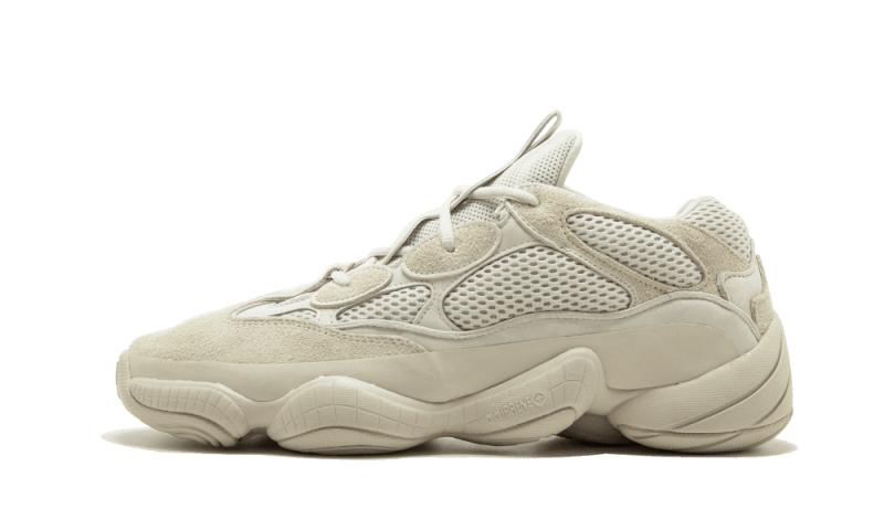 Side view of Adidas Yeezy 500 Bone White sneaker featuring a chunky sole, mesh and suede materials in a bone white color, showcasing exclusive European sneakers from The real deal.