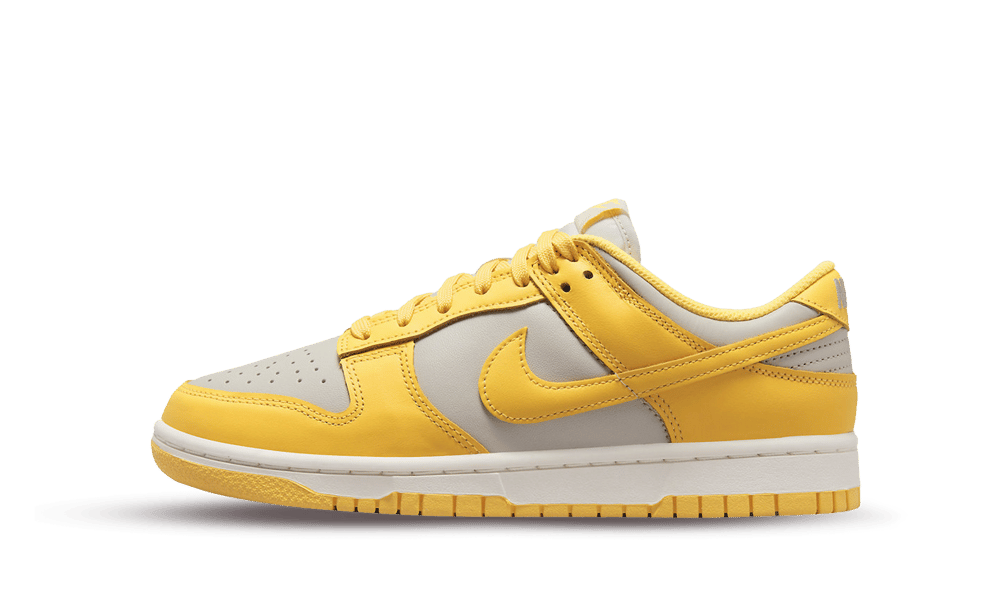 Side view of a Nike Dunk Low Citron Pulse sneaker featuring yellow leather overlays and light beige underlays, showcasing a classic low-top silhouette ideal for exclusive sneaker collectors in Europe.