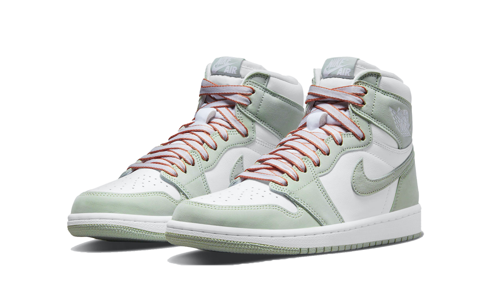 Pair of Nike Air Jordan 1 High OG Seafoam sneakers in white and pale green with contrasting pink laces, showcasing exclusive European sneaker style. The real deal.