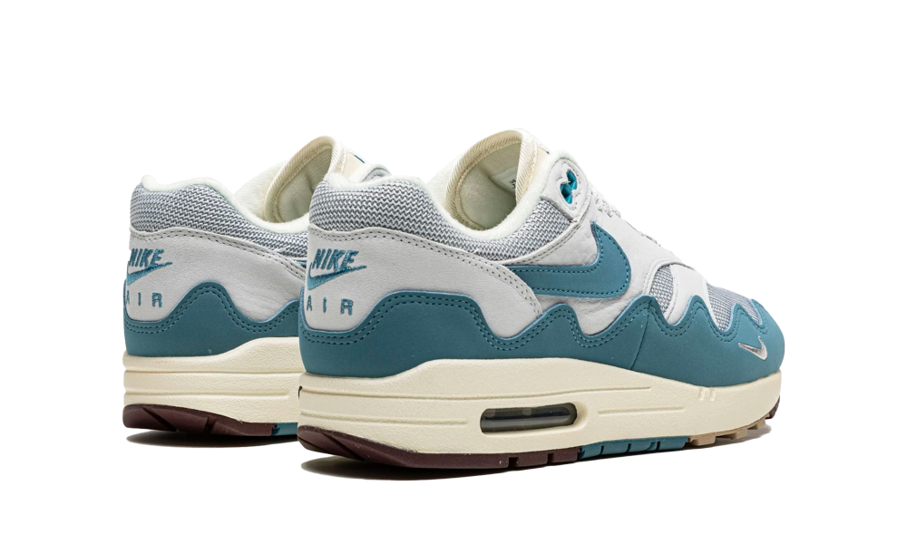 Pair of Nike Air Max 1 Patta Waves Noise Aqua sneakers in white and aqua tones, showcasing wave design and classic Air Max sole, exclusive sneakers sold in whole Europe, the real deal.