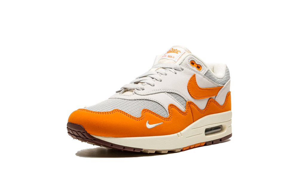 Nike Air Max 1 Patta Waves Monarch sneaker in white and orange with wave patterns, showcasing exclusive European designer trainers known as The real deal.